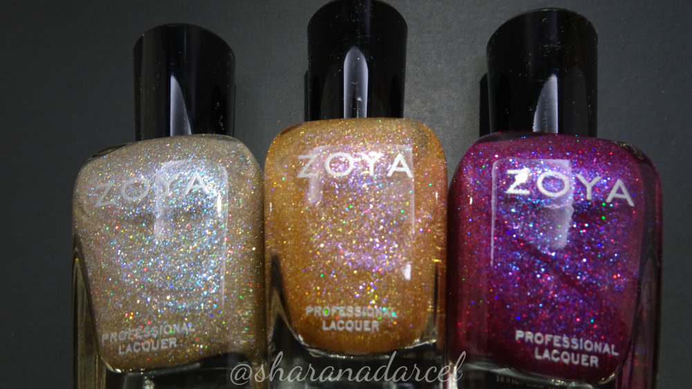 Close up of three nail polish bottles from Zoya, showing the holographic rainbow sparkles