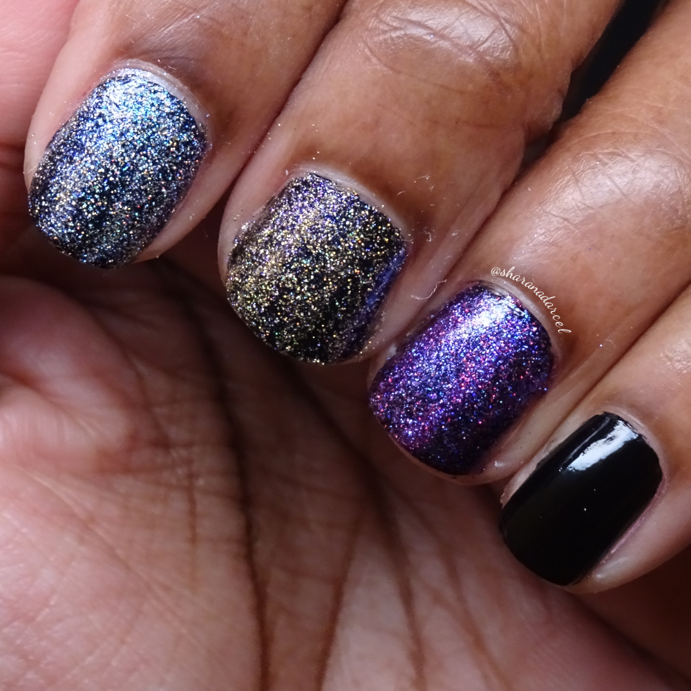 Zoya Celestia, Polaris, and Eradani nail polishes layered over black polish, worn on short nails against dark skin