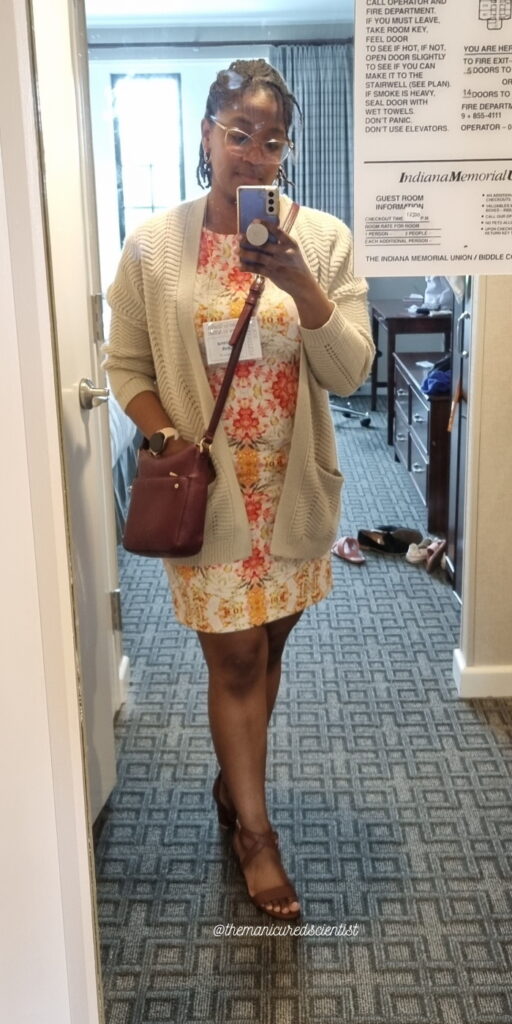 Sharana wearing a floral dress and Pashion sandals in a hotel room